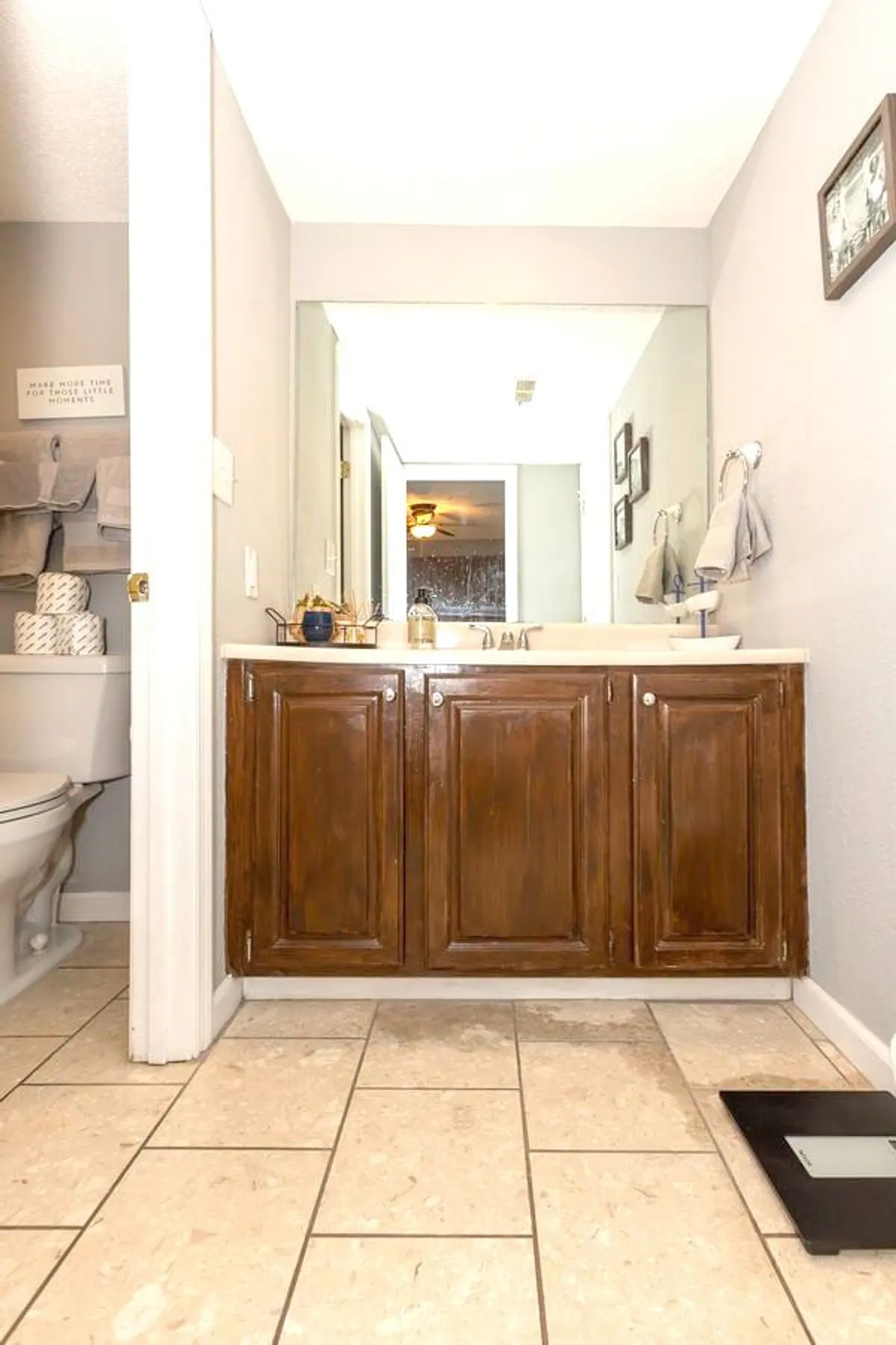 A calm, well-appointed bathroom with wooden cabinets, a sink area, a mirror, towels, and decorative items. The organized space invites relaxation and supports serene routines before bed or after lake days.